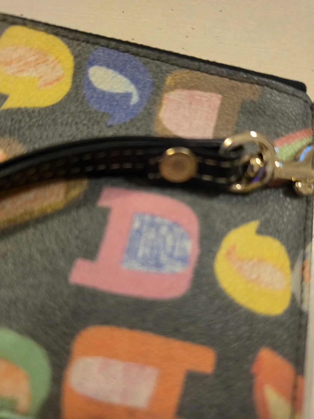 Dooney & Bourke Vintage multicolor letter/graffiti print coated Wristlet